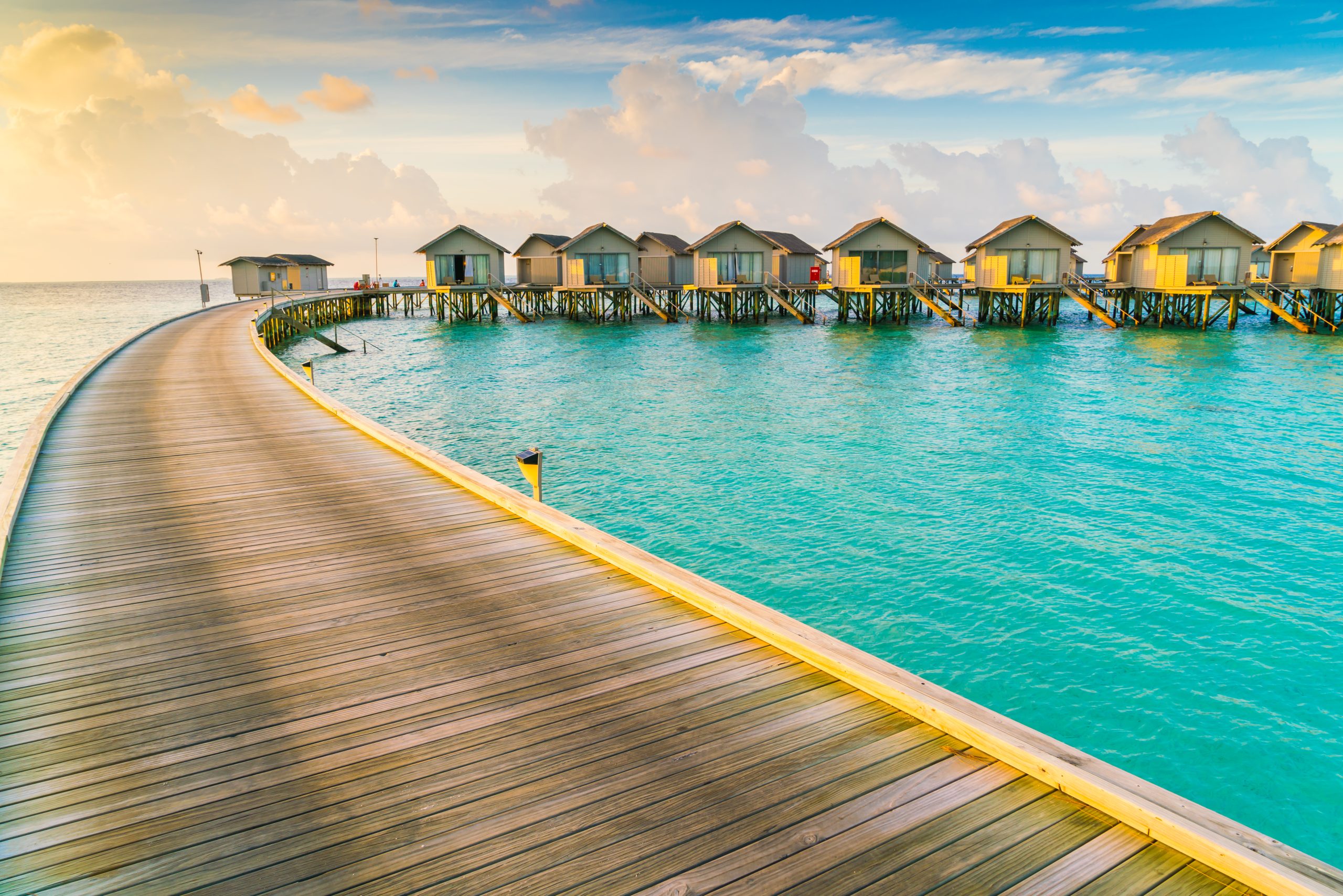 Beautiful water villas in tropical Maldives island at the sunris